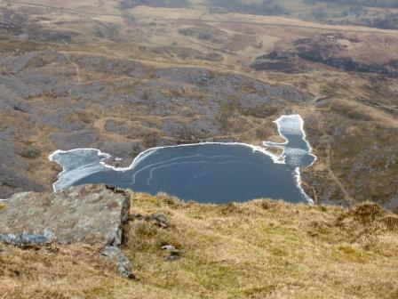 Mountain tarn with frozen edges