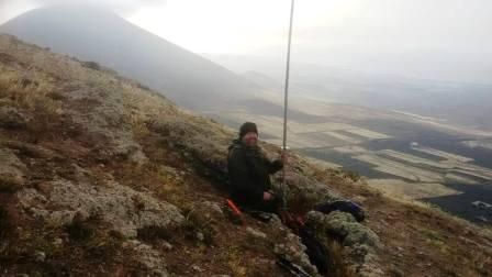 Tom hanging on to the mast in the wind!