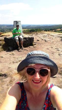 Marianne selfie with Tom in the background