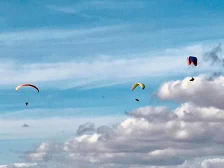 Hang gliders playing over Shining Tor