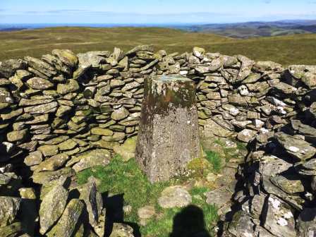 Trig point enclosed in the summit shelter