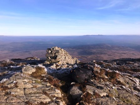 A drystone wall terminating at the summit