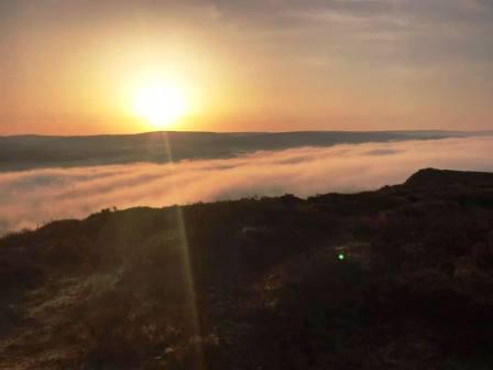 Sunrise over a mist-filled valley