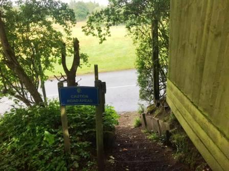Path emerges at the main entrance to the golf club
