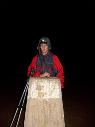 Jimmy reaches the trig point on Walton Hill summit, rather late!