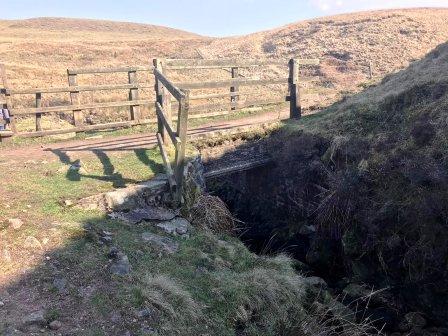 Footpath climbs slightly to cross a bridge