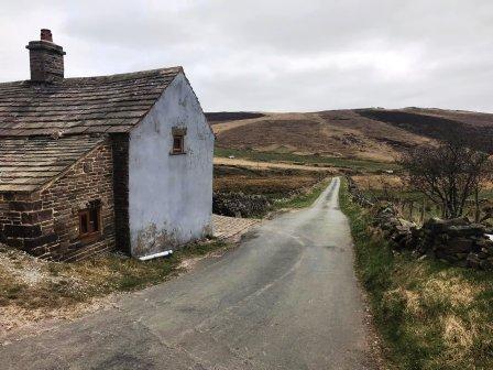 Pass the farmhouse and continue straight on