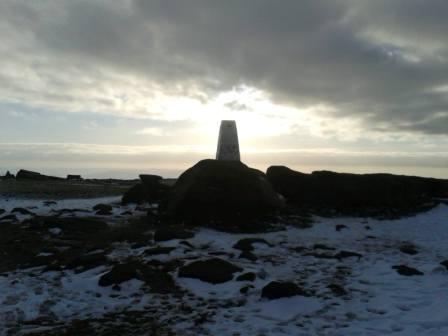 Trig point under low midwinter sun