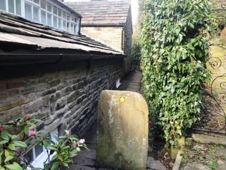 Footpath down a narrow passageway behind a house