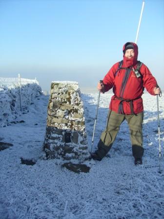 Tom by the trig point en route to the summit