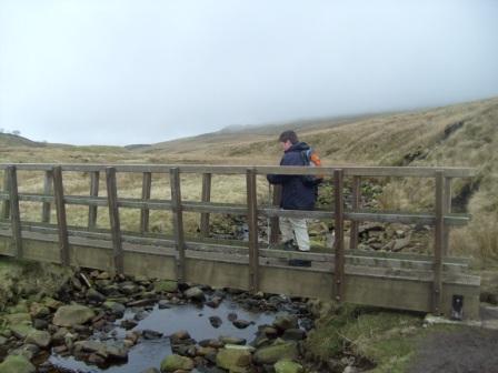 Liam on a wooden footbridge