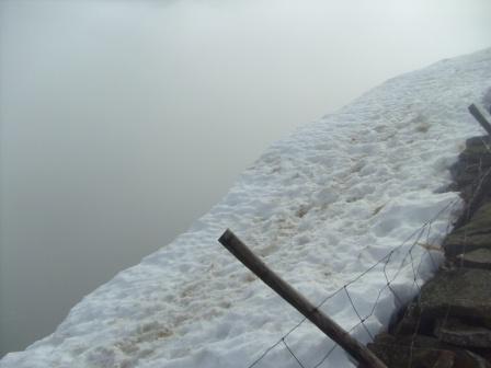 Deep snow by the wall on the summit ridge - just how much of that is a cornice over the sheer edge?