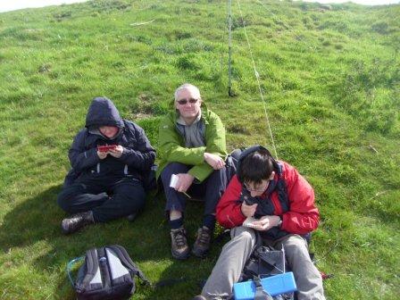 Liam on his DS again, Richard G3CWI basking after getting his four contacts, and Jimmy working the radio to get his