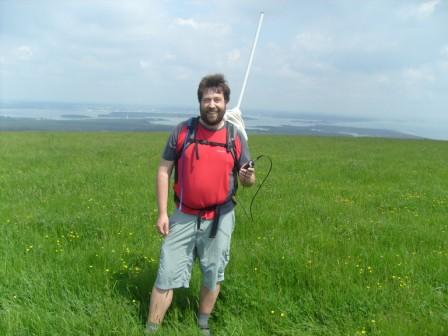 Tom on summit with Brownsea Island behind