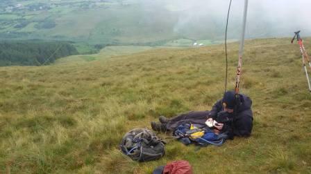 In a sheltered spot on a very windy summit