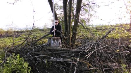 Jimmy using the trig point to support the antenna