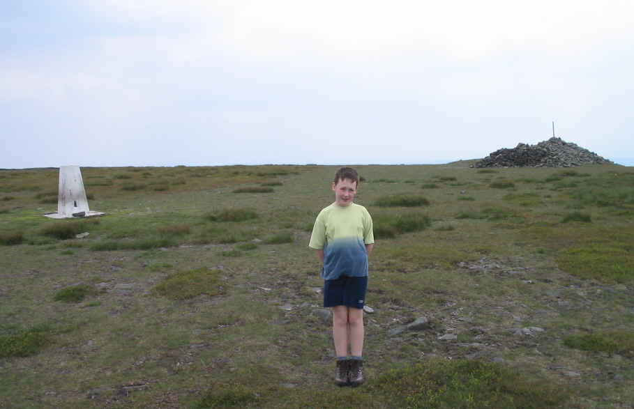 Jimmy on Fair Snape Fell SP-007, also showing the trig point and the shelter