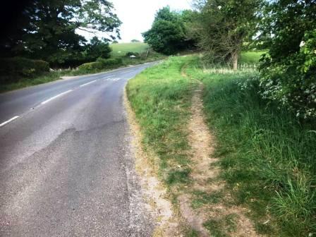 Welcome path veering off the main road into the grass verge