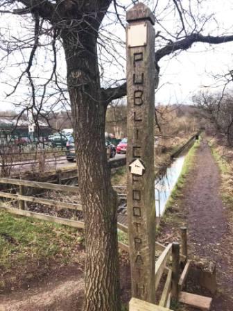 Public footpath sign at the road