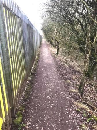 The long straight footpath coming into more industrial areas